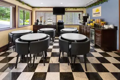 a restaurant with tables and stools in a kitchen at Days Inn by Wyndham Wurtsboro in Wurtsboro