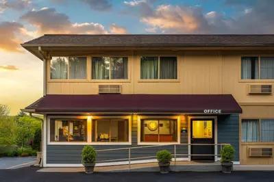 a office building with a purple awning on it at Days Inn by Wyndham Wurtsboro in Wurtsboro