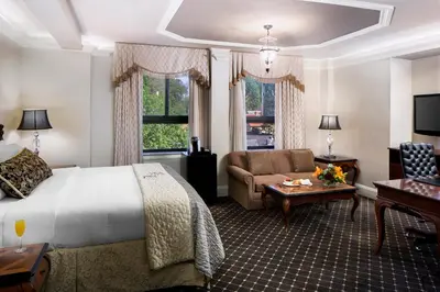 a hotel room with a bed and a couch and a table at Historic Hotel Bethlehem in Bethlehem