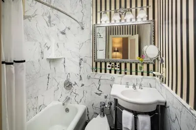 a white bathroom with a sink and a mirror at Historic Hotel Bethlehem in Bethlehem