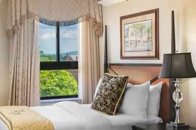 a bedroom with a white bed and a window at Historic Hotel Bethlehem in Bethlehem
