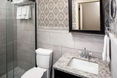 a bathroom with a toilet and a sink and a mirror at Historic Hotel Bethlehem in Bethlehem