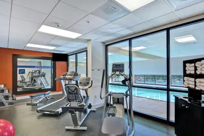 a gym with cardio machines and a swimming pool at Hampton Inn Lewisburg in Lewisburg