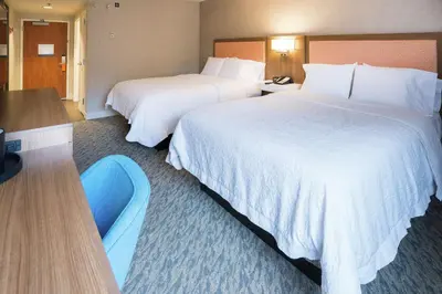 a hotel room with two beds and a desk at Hampton Inn Clarks Summit in Clarks Summit