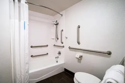 a bathroom with a shower and a toilet at Hampton Inn Clarks Summit in Clarks Summit