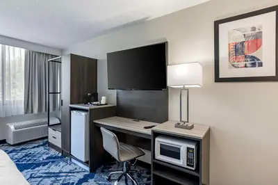 a hotel room with a desk and a computer at Best Western Rutgers University Hotel in East Brunswick