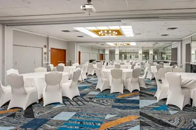 a conference room with white tables and white chairs at Best Western Rutgers University Hotel in East Brunswick