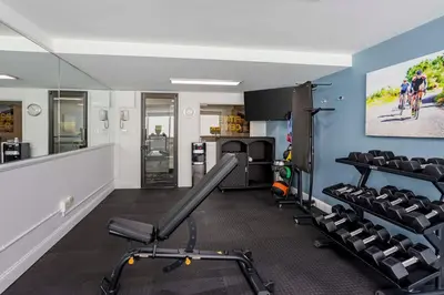 a gym with treadmills and chairs in a room at Best Western Rutgers University Hotel in East Brunswick