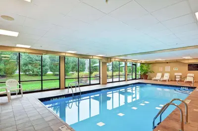 a large swimming pool with windows in a building at Hampton Inn Sayre in Sayre