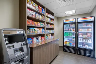 a convenience store with a drink cooler and a soda machine at Sleep Inn & Suites Monroe - Woodbury in Monroe