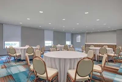 a conference room with white tables and chairs at Home2 Suites By Hilton Bordentown in Bordentown
