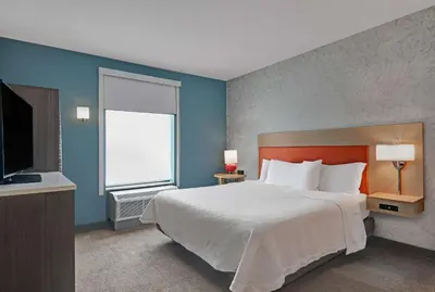a bedroom with a large bed and a window at Home2 Suites By Hilton Bordentown in Bordentown
