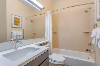 a bathroom with a sink and a toilet and a tub at Candlewood Suites Bethlehem South by IHG in Bethlehem