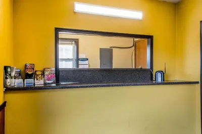 a mirror on a yellow wall in a bathroom at Relax Inn in Lewisburg