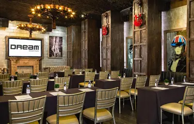 a conference room with tables and chairs and a screen at Dream Downtown, by Hyatt in New York