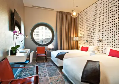 a hotel room with two beds and a desk and a window at Dream Downtown, by Hyatt in New York