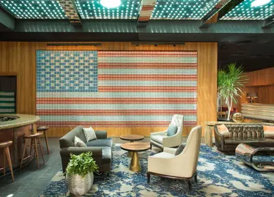 an american flag on a wall in a room with chairs at Dream Downtown, by Hyatt in New York