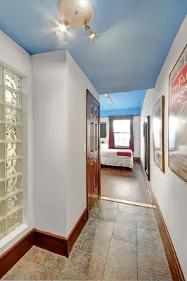 a hallway with a room with a bed and a ceiling at Chelsea Pines Inn in New York