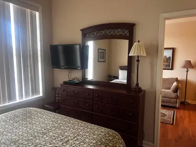 a bedroom with a dresser with a mirror and a bed at Hotel Belvidere in Belvidere