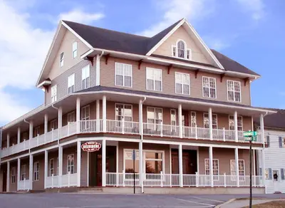 a large brown building with white trim at Hotel Belvidere in Belvidere