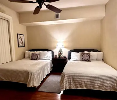 a bedroom with two beds and a ceiling fan at Hotel Belvidere in Belvidere