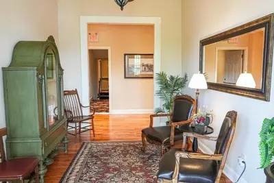 a living room with chairs and a mirror at Hotel Belvidere in Belvidere
