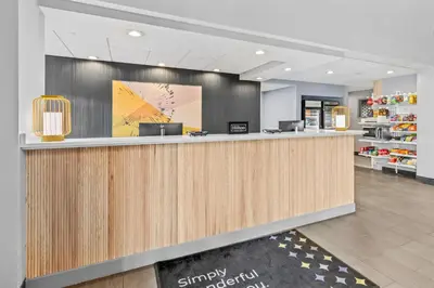 a lobby with a reception counter in a store at Spark by Hilton Mechanicsburg in Mechanicsburg
