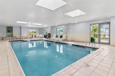 a pool with blue water in a hotel room at Spark by Hilton Mechanicsburg in Mechanicsburg