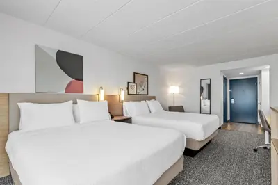 a hotel room with two beds and a tv at Spark by Hilton Mechanicsburg in Mechanicsburg
