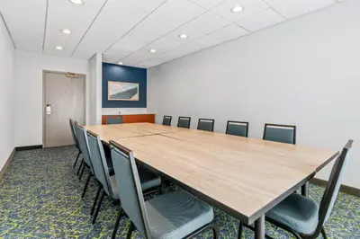 a conference room with a long table and chairs at Spark by Hilton Mechanicsburg in Mechanicsburg