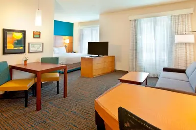 a hotel room with a bed and a living room at Residence Inn Bridgewater Branchburg in Branchburg Park