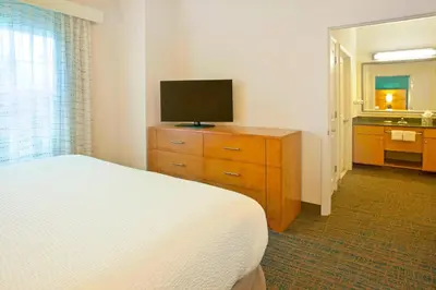 a bedroom with a bed and a television on a dresser at Residence Inn Bridgewater Branchburg in Branchburg Park