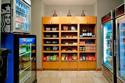 a store aisle with a refrigerator and shelves of food at Residence Inn Bridgewater Branchburg in Branchburg Park