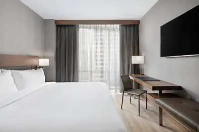 a hotel room with a large bed and a desk at AC Hotel by Marriott New York Downtown in New York