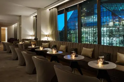 a restaurant with tables and chairs and a large window at AC Hotel by Marriott New York Downtown in New York