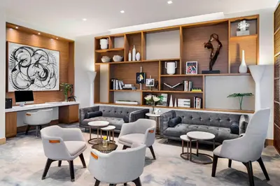 a living room with a couch and tables and chairs at AC Hotel by Marriott New York Downtown in New York