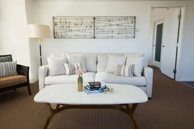 a living room with a couch and a coffee table at The Study at University City, Study Hotels in Philadelphia
