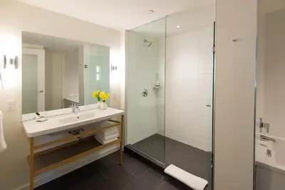 a bathroom with a sink and a shower at The Study at University City, Study Hotels in Philadelphia