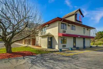 a white building with a sign on it at Motel 6 Carlisle, PA - Cumberland Valley in Carlisle