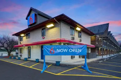 a now open sign in front of a building at Motel 6 Carlisle, PA - Cumberland Valley in Carlisle