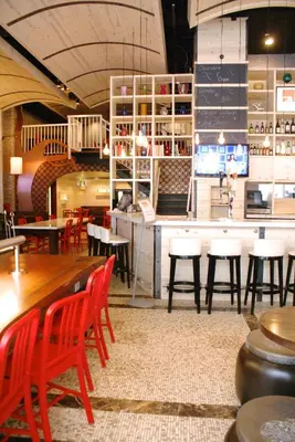 a restaurant with tables and chairs and a bar at TRYP by Wyndham New York City Times Square - Midtown in New York