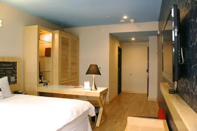 a bedroom with a bed and a desk and a chalkboard at TRYP by Wyndham New York City Times Square - Midtown in New York