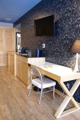 an office with a desk and a tv on a wall at TRYP by Wyndham New York City Times Square - Midtown in New York