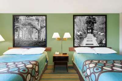 two beds in a room with green walls at Super 8 by Wyndham Harrisburg Hershey West in Harrisburg