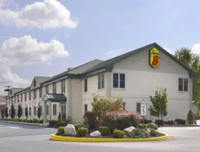 a large white building with a sign in front of it at Super 8 by Wyndham Harrisburg Hershey West in Harrisburg