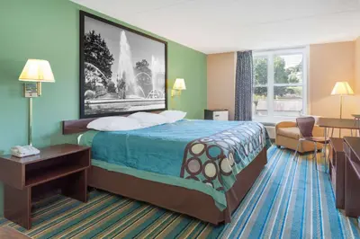 a hotel room with a bed and a window at Super 8 by Wyndham Harrisburg Hershey West in Harrisburg