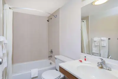 a bathroom with a sink and a toilet and a tub at Super 8 by Wyndham Harrisburg Hershey West in Harrisburg