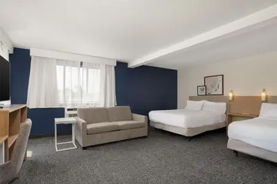 a hotel room with two beds and a couch at Spark by Hilton Carlisle South in Carlisle
