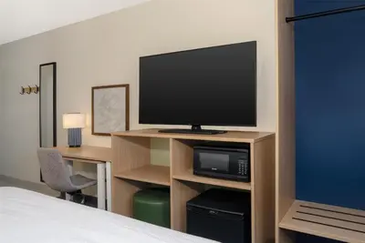 a hotel room with a television and a bed at Spark by Hilton Carlisle South in Carlisle
