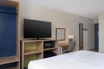 a hotel room with a bed and a flat screen tv at Spark by Hilton Carlisle South in Carlisle